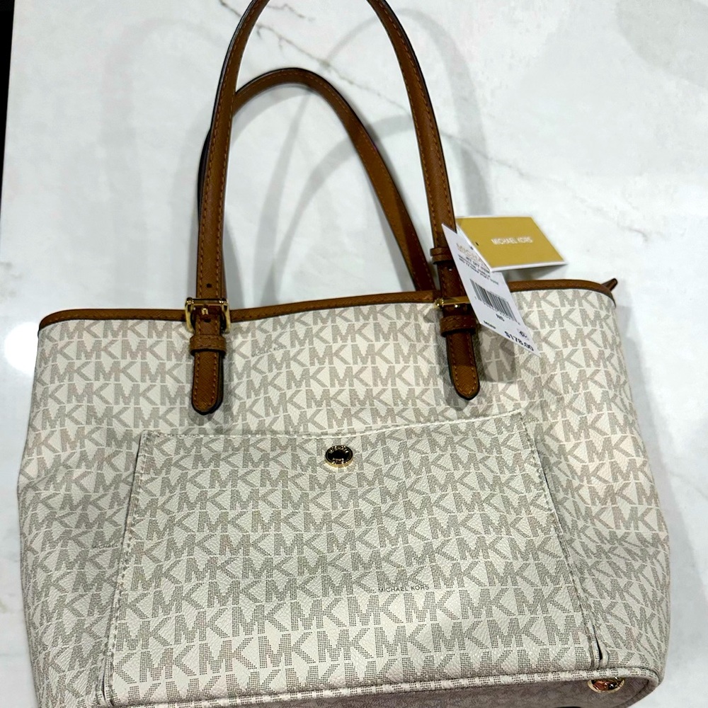 Michael Kors vanilla jet set tote with front snap pocket.